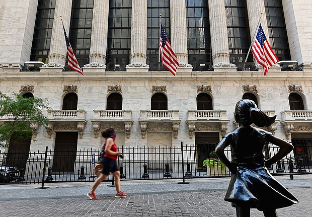 People pass by The New York Stock Exchange (NYSE) on August 3, 2020 at Wall Street in New York City. - Stock markets rose on both sides of the Atlantic August 3, 2020 as hopeful economic data prompted bargain hunting, with some of Asia's equities markets also making solid gains./Credit:	Angela Weiss/AFP/Getty Images