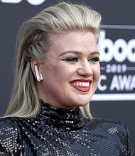Kelly Clarkson, seen here at the 2019 Billboard Music Awards in 2019, is filling in for judge Simon Cowell this week on "America's Got Talent."/Credit:	Frazer Harrison/Getty Images