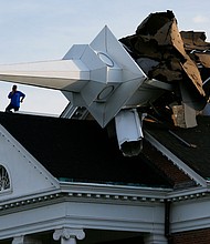 A person surveys the damage from the roof of College Church in Wheaton, Illinois after a severe storm toppled the church steeple on the campus of Wheaton College on Aug. 10, 2020./Credit:	Mark Hume/Chicago Tribune/Tribune News Service/Getty Images