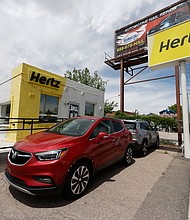 Rental vehicles are parked outside a closed Hertz car rental office Saturday, May 23, 2020, in south Denver./Credit:	David Zalubowski/AP