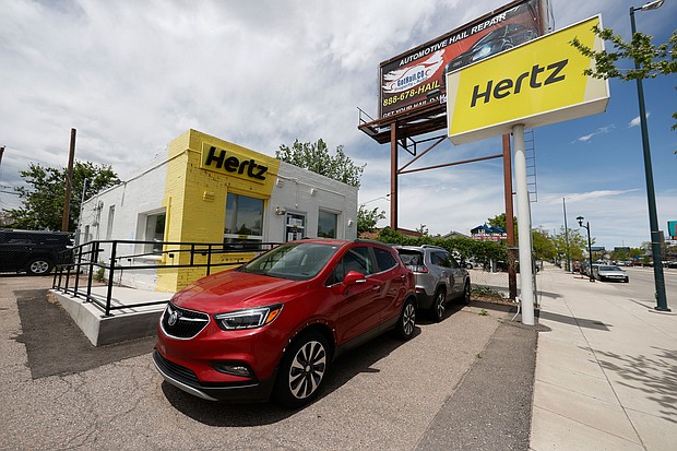Rental vehicles are parked outside a closed Hertz car rental office Saturday, May 23, 2020, in south Denver./Credit:	David Zalubowski/AP