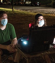 Alex Criqui, left, and Dustin Klein bring their understanding of history and technology to their nightly projections of images of African-Americans onto the Lee statue at Monument Avenue.