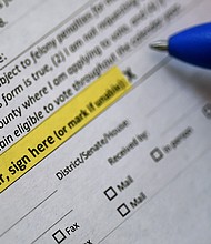 This illustration photo shows a Virginia resident filling out an application to vote by mail ahead of the November Presidential election, on August 6, 2020 in Arlington, Virginia./Credit:	Olivier Douliery/AFP/Getty Images