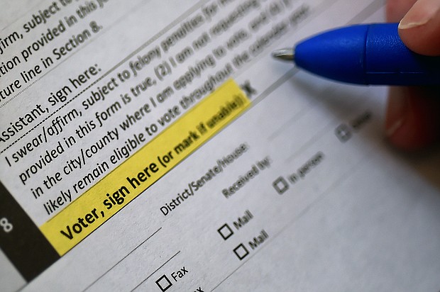 This illustration photo shows a Virginia resident filling out an application to vote by mail ahead of the November Presidential election, on August 6, 2020 in Arlington, Virginia./Credit:	Olivier Douliery/AFP/Getty Images