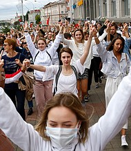 Women in Minsk march in solidarity with protesters injured in a post-election police crackdown last week./Credit:	AP
