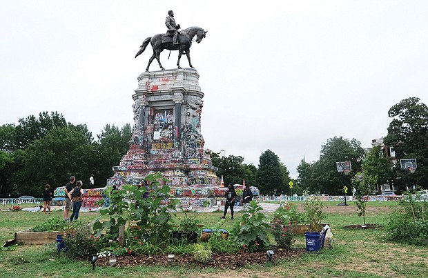 The sign placed months ago by demonstrators designated the circle around the Lee statue on Monument Avenue as Marcus-David Peters Circle apparently was sawed off and
removed early last Sunday, prompting the Richmond Police Department to issue a news release disavowing any association with its removal. 
The statement read: “The Richmond Police Department is seeking information about the removal of the MDP sign from the Circle. No city agency was involved — including the RPD. It is illegal to remove  signage without permission. Whoever did this may be trying to spark more violence in the City of Richmond. Please know  that the RPD stands with peaceful demonstrators and will not tolerate those who seek a different, destructive path.” The police department asked that anonymous tips on the sign’s removal be given to Crime Stoppers at (804) 780-1000 or by using the P3 smartphone app. The photos show the sign inside the circle on July 10, and the post stubs that remained later on Sunday.