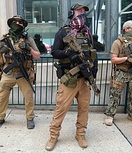 Armed members from private militia groups advocate for gun rights at Ninth and Main streets near the State Capitol before marching to the Siegel Center on Broad Street, where the House of Delegates was meeting tuesday in a special session. Several organizations held rallies on the opening day of the special General Assembly session, where lawmakers are taking up criminal justice, police reform and budget measures.