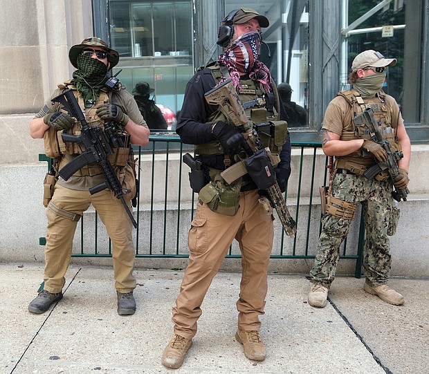 Armed members from private militia groups advocate for gun rights at Ninth and Main streets near the State Capitol before marching to the Siegel Center on Broad Street, where the House of Delegates was meeting tuesday in a special session. Several organizations held rallies on the opening day of the special General Assembly session, where lawmakers are taking up criminal justice, police reform and budget measures.