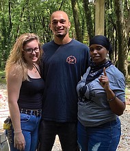Queen Richardson, right, and friends Olivia Wright and Jay Price were among the volunteers recently cleaning graffiti from historic cemeteries in Richmond.