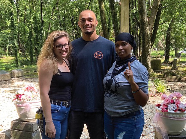 Queen Richardson, right, and friends Olivia Wright and Jay Price were among the volunteers recently cleaning graffiti from historic cemeteries in Richmond.