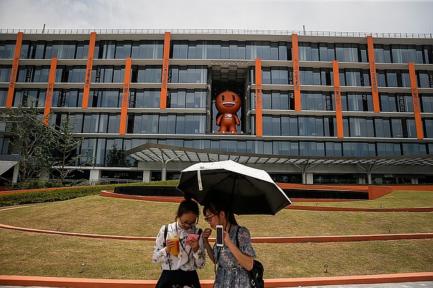 Two visitors in front Taobao model of Office Building at Alibaba Xixi Park on July 13, 2017 in Hangzhou, Zhejiang province of China. Alibaba sales soar but a crackdown from the US may be looming.
\Credit:	Wang He/Getty Images