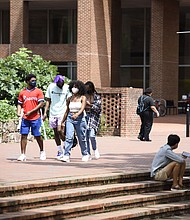 Students walk through the campus of the University of North Carolina at Chapel Hill in August. The university canceled classes after clusters of coronavirus cases appeared./Credit:	Melissa Sue Gerrits/Getty Images