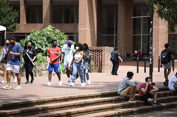 Students walk through the campus of the University of North Carolina at Chapel Hill in August. The university canceled classes after clusters of coronavirus cases appeared./Credit:	Melissa Sue Gerrits/Getty Images