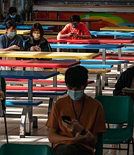 Students sit at a cafetaria ahead of Diploma of Secondary Education (DSE) exams on April 29, 2020 in Hong Kong, China. Temperature checks and social distancing measures to avoid the spread of COVID-19 have have been put in place in the schools for over 50,000 candidates who will sit for the DSE examination this year./Credit:	Anthony Kwan/Getty Images