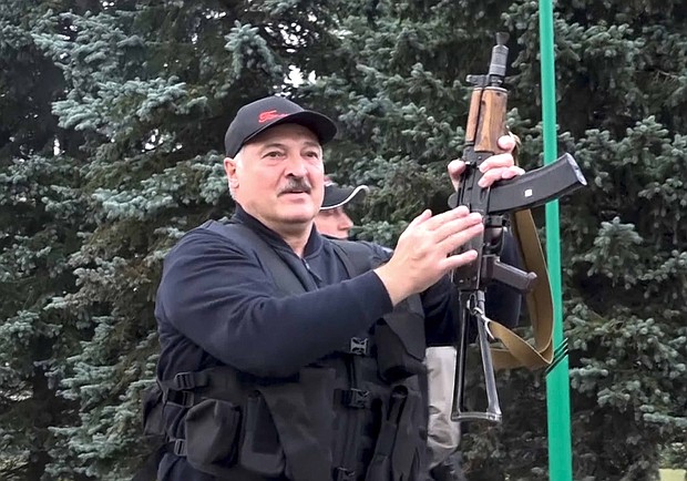 President Alexander Lukashenko brandishing a rifle near the Palace of Independence in Minsk, Sunday, as seen in video from state TV./Credit:	State TV and Radio Company of Belarus via AP