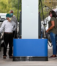 People wait in long lines for gas at Costo as they prepare for Hurricane Marco and Tropical Storm Laura on August 23, 2020 in New Orleans, Louisiana./Credit:	Sean Gardner/Getty Images