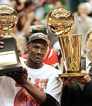Michael Jordan (L) and Chicago Bulls head coach Phil Jackson after the Bulls won their sixth NBA championship./Credit:	JEFF HAYNES/AFP/AFP via Getty Images
