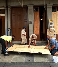 Workers board up windows in the French Quarter in anticipation of Hurricane Marco and Tropical storm Laura./Credit:	Sean Gardner/Getty Images