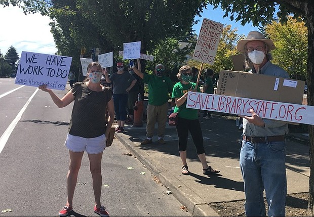 Multnomah County Library workers rally to save library jobs during a picket Monday outside the Midland Library at Southeast 122nd and Stark. (Submitted photo)