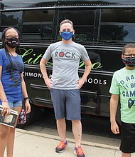 Richmond Schools Superintendent Jason Kamras, center, greets ninth-grader Chandler Holeman, left, and her brother, Chadwick Thaddeus Holeman II, during a recent Lit Limo stop at Overby-Sheppard Elementary School in North Side.