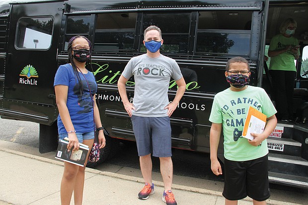 Richmond Schools Superintendent Jason Kamras, center, greets ninth-grader Chandler Holeman, left, and her brother, Chadwick Thaddeus Holeman II, during a recent Lit Limo stop at Overby-Sheppard Elementary School in North Side.