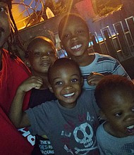 Jacob Blake was shot seven times in the back as an officer tried to detain him this week in Wisconsin. In this photo, Blake is seen with his four sons./Credit:	From Ben Crump/Twitter