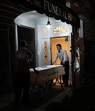 Omar Rodriguez (left) and Joseph Neufeld Jr. (right) carry a casket at the Gerard J. Neufeld funeral home in Queens, New York on April 29, 2020./Credit:	Tayfun Coskun/Anadolu Agency/Getty Images