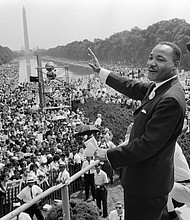 Martin Luther King waves to supporters during the 1963 March on Washington./Credit:	AFP/Getty Images