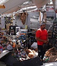 Ahmed Nawaz looks through the damage to his store after Hurricane Laura passed through Lake Charles, Louisiana./Credit:	Elijah Nouvelage/Reuters