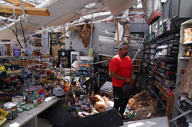 Ahmed Nawaz looks through the damage to his store after Hurricane Laura passed through Lake Charles, Louisiana./Credit:	Elijah Nouvelage/Reuters