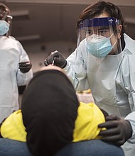 Health care workers use a nasal swab to test a person for COVID-19 at a pop up testing site at the Koinonia Worship Center and Village on July 22, 2020 in Pembroke Park, Florida./Credit:	Joe Raedle/Getty Images