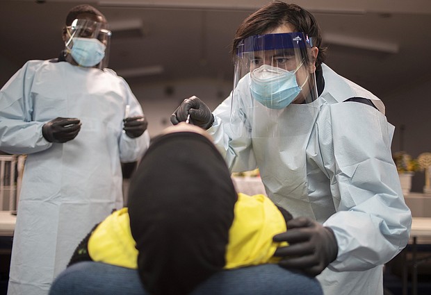 Health care workers use a nasal swab to test a person for COVID-19 at a pop up testing site at the Koinonia Worship Center and Village on July 22, 2020 in Pembroke Park, Florida./Credit:	Joe Raedle/Getty Images