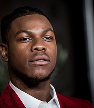 When Disney first revealed John Boyega as a stormtrooper in "The Force Awakens," he immediately became the target of racist comments from "Star Wars" fans protesting the casting of a Black person in the role./Credit:	Tristan Fewings/Getty Images