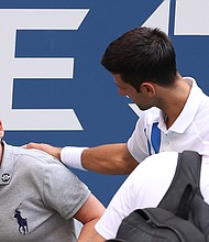 Novak Djokovic apologizes to the line judge./Credit:	Al Bello/Getty Images North America/Getty Images