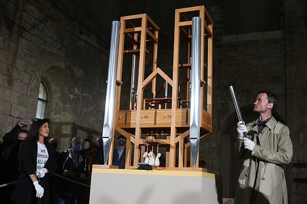 Soprano Johanna Vargas and composer Julian Lembke use the organ pipes during the chord change ceremony./Credit:	Matthias Bein/picture alliance/dpa/Getty Images