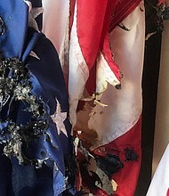 Several flags placed in downtown Waynesville by the local Kiwanis Club for Labor Day were stolen and burned./Credit:	WLOS Staff