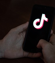 TikTok is working to take down a graphic and disturbing video showing a man shooting himself with a gun./Credit:	Ivan Abreu/Bloomberg/Getty Images