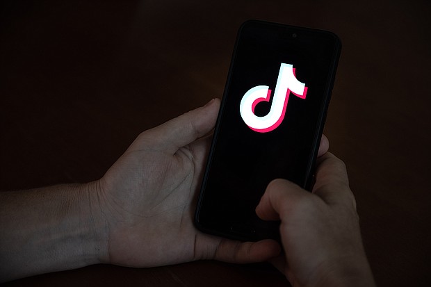 TikTok is working to take down a graphic and disturbing video showing a man shooting himself with a gun./Credit:	Ivan Abreu/Bloomberg/Getty Images
