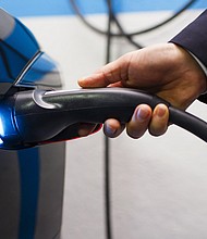An Uber Technologies Inc. driver plugs a charging cable into a Tesla Motors Inc. Model S electric automobile in Madrid, Spain, on Friday, Jan. 13, 2017./Credit:	Angel Navarrete/Bloomberg/Getty Images