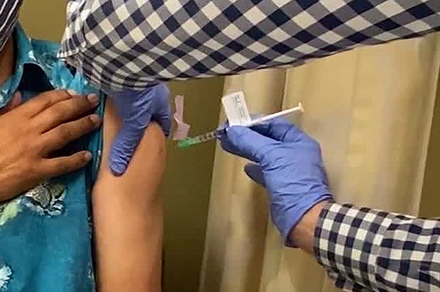 A man receives an injection as UCLA. Drug giant AstraZeneca said it had paused global trials of its coronavirus vaccine because of an unexplained illness in one of the volunteers./Credit:	The Lundquist Institute/FILE