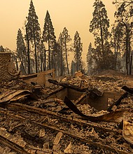 A community of forest homes lies in ruins along Auberry Road in the Meadow Lakes area after the Creek Fire swept through on September 8, 2020 near Shaver Lake, California./Credit:	David McNew/Getty Images