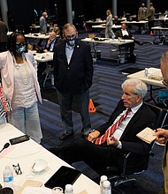 Sen. Richard Saslaw, D-Fairfax, seated, talks with Sen. Tommy Norment, R-James City County, right, and Sen. Janet Howell, D-Fairfax, left, Sen. Mamie Locke, D-Hampton, and Sen. Adam Ebbin, D-Alexandria, last month during the Virginia Special Session in the temporary Senate chambers at the Science Museum of Virginia.