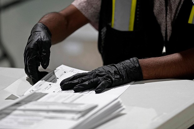 A workers prepares absentee ballots for mailing at the Wake County Board of Elections in Raleigh, N.C., on September 3, 2020./Credit:	Gerry Broome/AP