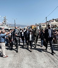 Greece's President Katerina Sakellaropoulou, center, is cheered by residents during her visit to Kastellorizo./Credit:	Thodoris Manolopoulos/Greek President's Office/AP