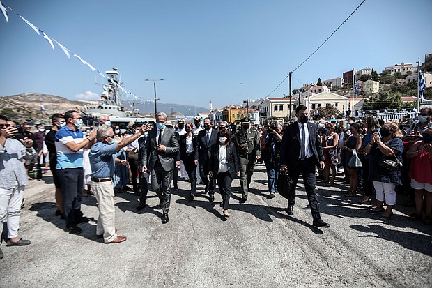 Greece's President Katerina Sakellaropoulou, center, is cheered by residents during her visit to Kastellorizo./Credit:	Thodoris Manolopoulos/Greek President's Office/AP
