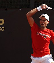 Djokovic returns a forehand during a practice session in Rome, Italy./Credit:	CLIVE BRUNSKILL/AFP/POOL/AFP via Getty Images