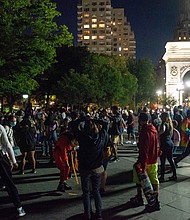 People with and without masks gather in Washington Square Park at night as the city continues Phase 4 of re-opening following restrictions imposed to slow the spread of coronavirus on September 12, 2020 in New York City.
Credit:	Alexi Rosenfeld/Getty Images