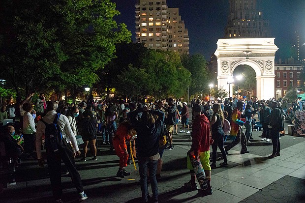 People with and without masks gather in Washington Square Park at night as the city continues Phase 4 of re-opening following restrictions imposed to slow the spread of coronavirus on September 12, 2020 in New York City.
Credit:	Alexi Rosenfeld/Getty Images