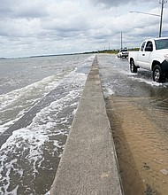 Waters from the Guld of Mexico pour onto a road Monday in Waveland, Mississippi, as Hurricane Sally closed in./Credit:	Gerald Herbrt/AP