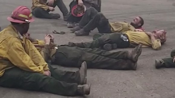 Sprawled on a smoky street, a crew of Oregon firefighters belted out a song after a long day fighting fires.